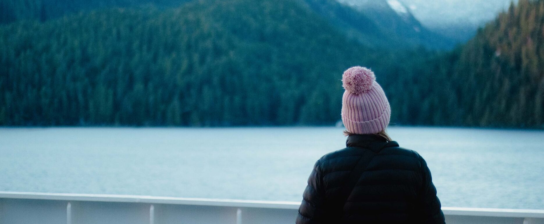 Woman with pink beanie looking off the inside passage ferry.