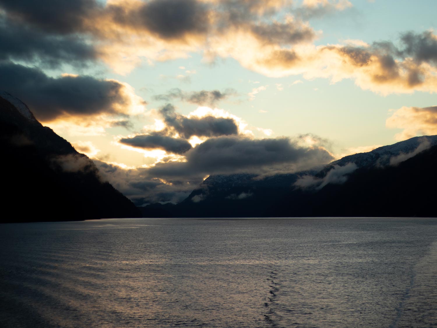 Inside Passage Ferry BC Sunrise and full moon on the deck surrounded by mountains