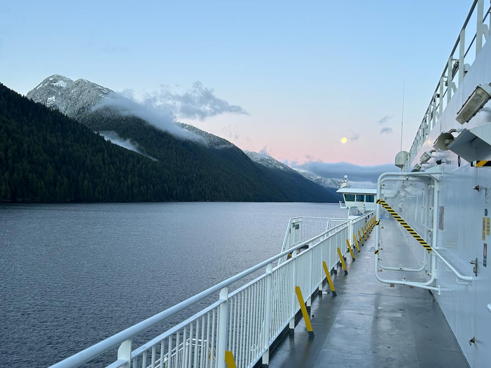 Inside Passage Ferry BC Sunrise and full moon on the deck surrounded by mountains